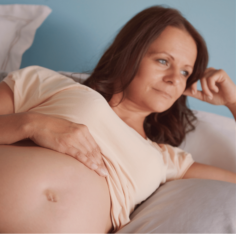 A pregnant woman woman thinking