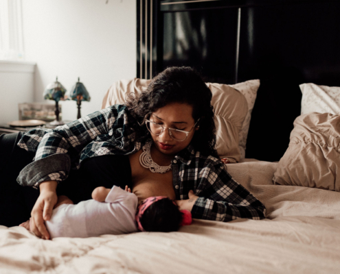 mother breastfeeding baby to sleep